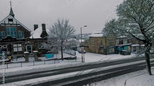 Winter wonderland transformation in a quaint village with snowy streets and cozy buildings in Harrogate, UK