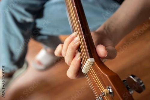 Hand Playing Acoustic Guitar Close-Up, hobby practicing chords, acoustic guitarist studying fretboard