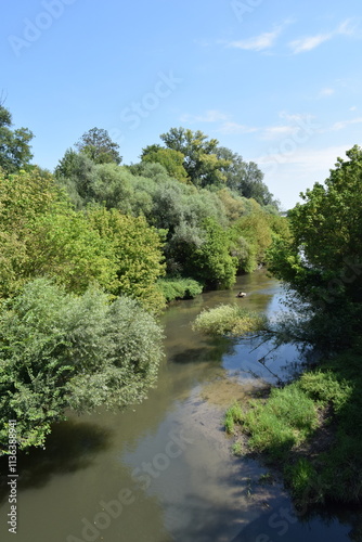 The Fischa River in Fischamend, Lower Austria on a sunny summer day. It is a right tributary of the Danube River.