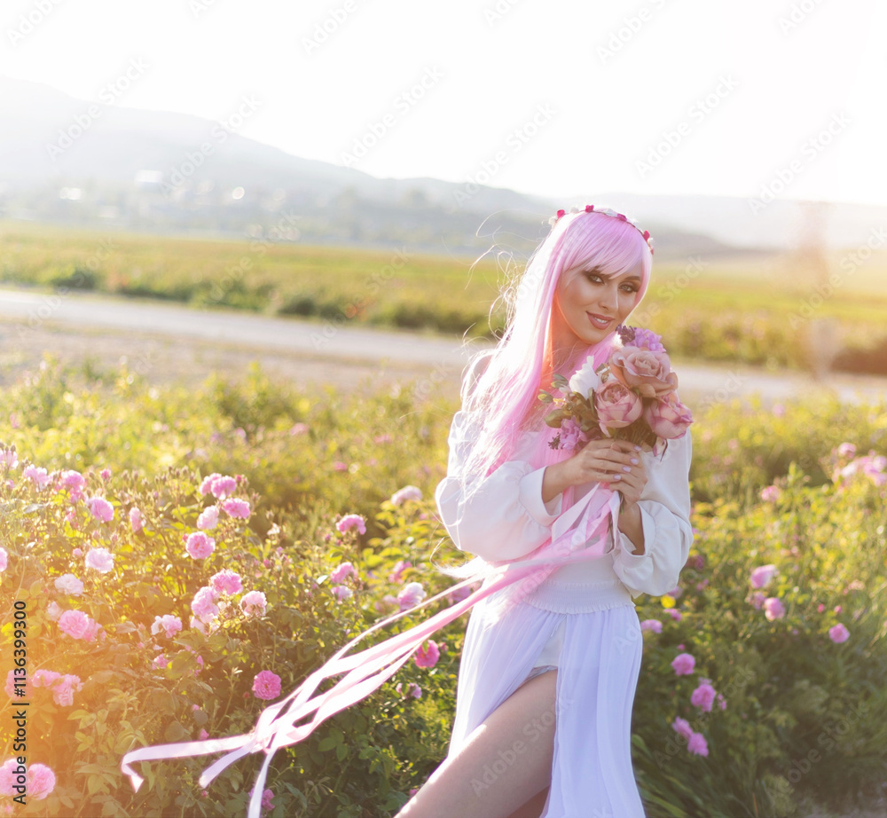 Beautiful woman in a floral park, garden roses. Makeup, hair, a wreath of roses.