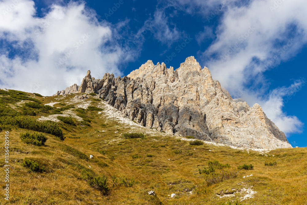 Fototapeta premium Autumn mountains. Alps in autumn colors. Dolomites beautiful yellow tree leaves autumn landscape. Alpine scenery of golden autumn