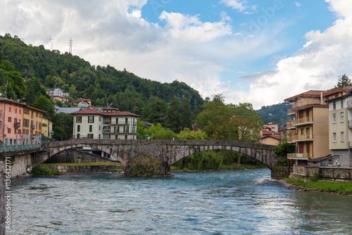 Obraz na płótnie SAN PELLEGRINO TERME, ITALY - MAY 12, 2024: Old bridge over the river in San Pellegrino Terme w salonie