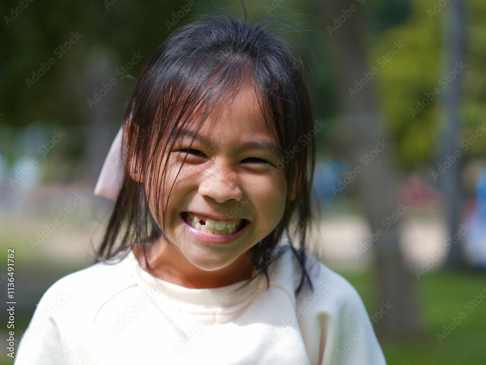 Portrait of a smiling little girl in a park on a sunny day. Portrait of a smiling little girl in a park on a sunny day.