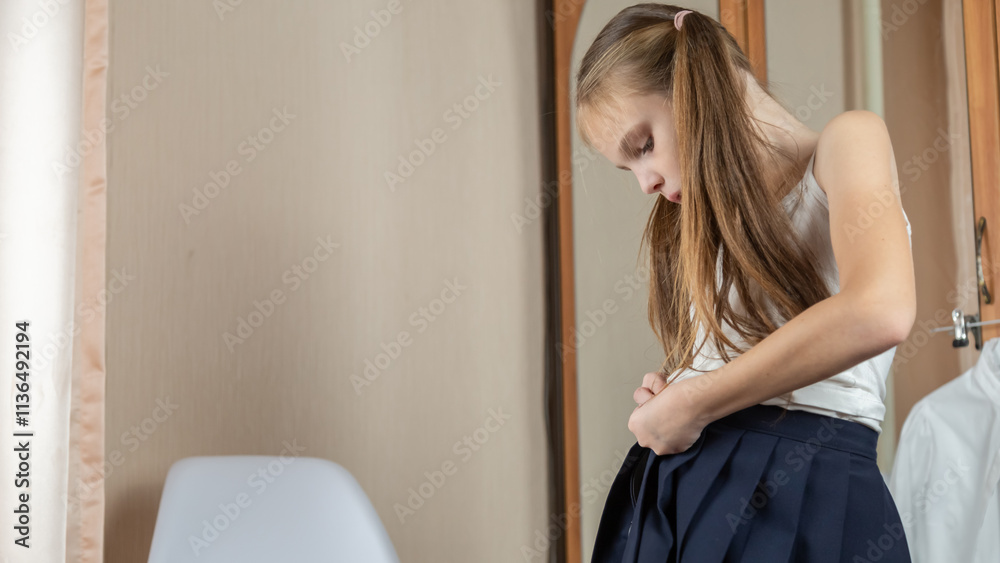 Little girl getting dressed school uniform in her room and preparing go to school Little girl getting dressed school uniform in her room and preparing go to school