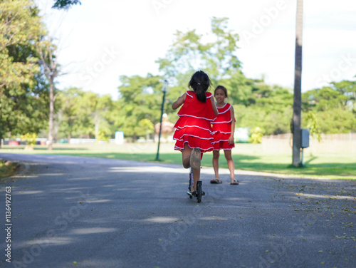 Wallpaper Mural Cute sisters riding scooters on a sunny summer day in the park. Active leisure and outdoor sport for child. Torontodigital.ca