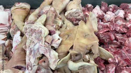 Pig head raw meat for sale on shelf at supermarket.