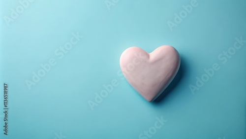 A Pale Pink Heart Shaped Object on a Light Blue Background
