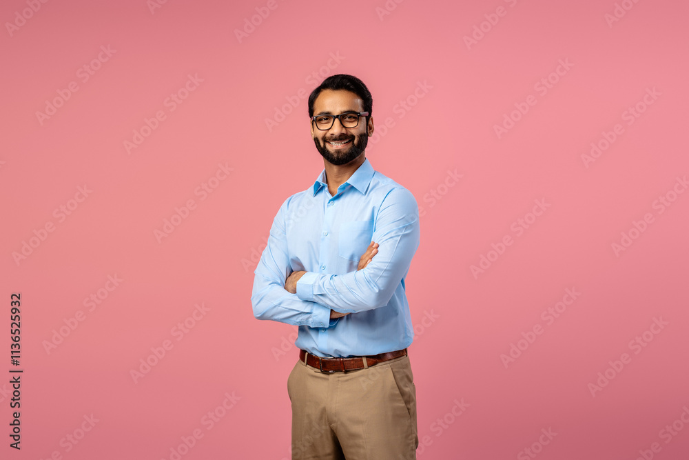 Confident successful Indian bearded man wearing formal wear and stylish eyeglasses with crossed arms Confident successful Indian bearded man wearing formal wear and stylish eyeglasses with crossed arms