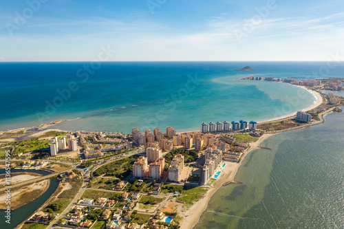 Aerial view of The Sandbar of the Minor Sea, is a seaside spit of Mar Menor in the Region of Murcia, Spain. The strip is 21 km long separating the Mediterranean Sea from the Mar Menor lagoon. Travel