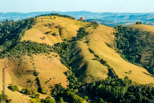 Exuberant hot air balloon ride through the interior of Brazil between mountains in an adventure with panoramic views of the landscape. photo