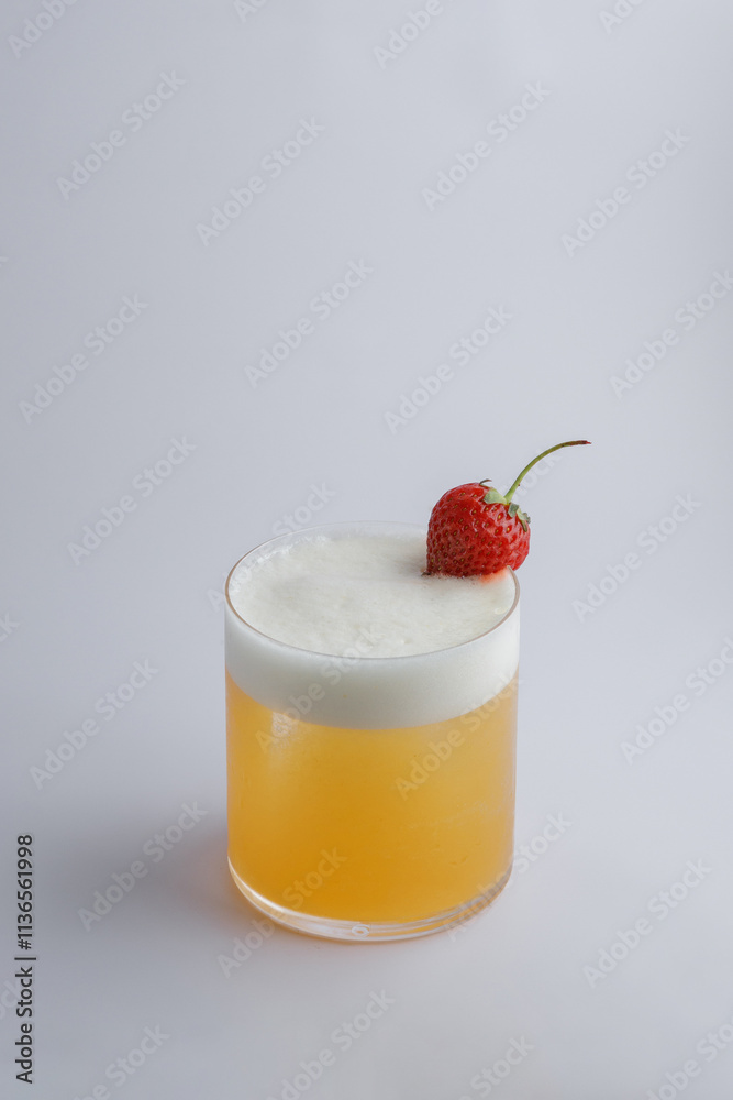 A refreshing drink that features a delightful strawberry on top A refreshing drink that features a delightful strawberry on top