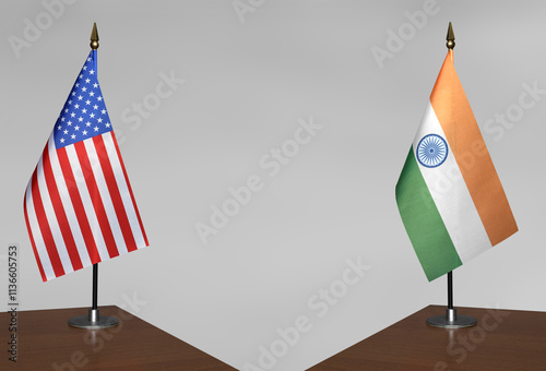 Table flags of USA and India on a gray blurred background