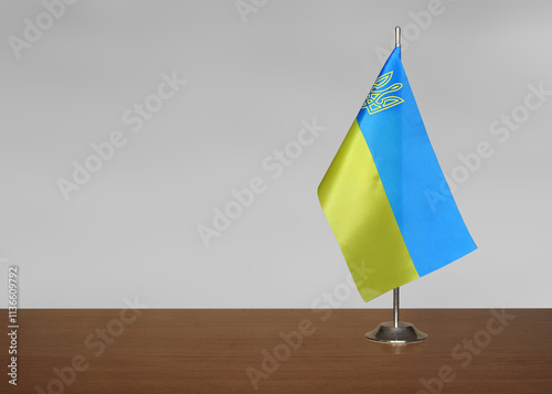 Ukraine table flag on gray blurred background