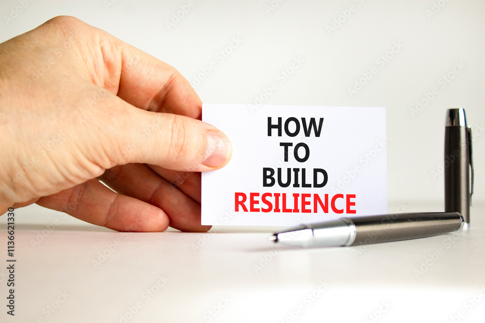 How to build resilience symbol. Concept words How to build resilience on beautiful white paper. Beautiful white background. Businessman hand. Business and how to build resilience concept. Copy space How to build resilience symbol. Concept words How to build resilience on beautiful white paper. Beautiful white background. Businessman hand. Business and how to build resilience concept. Copy space