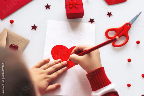 One toddler boy draws a card with a heart on Valentine's day, to his mother on Mother's day.