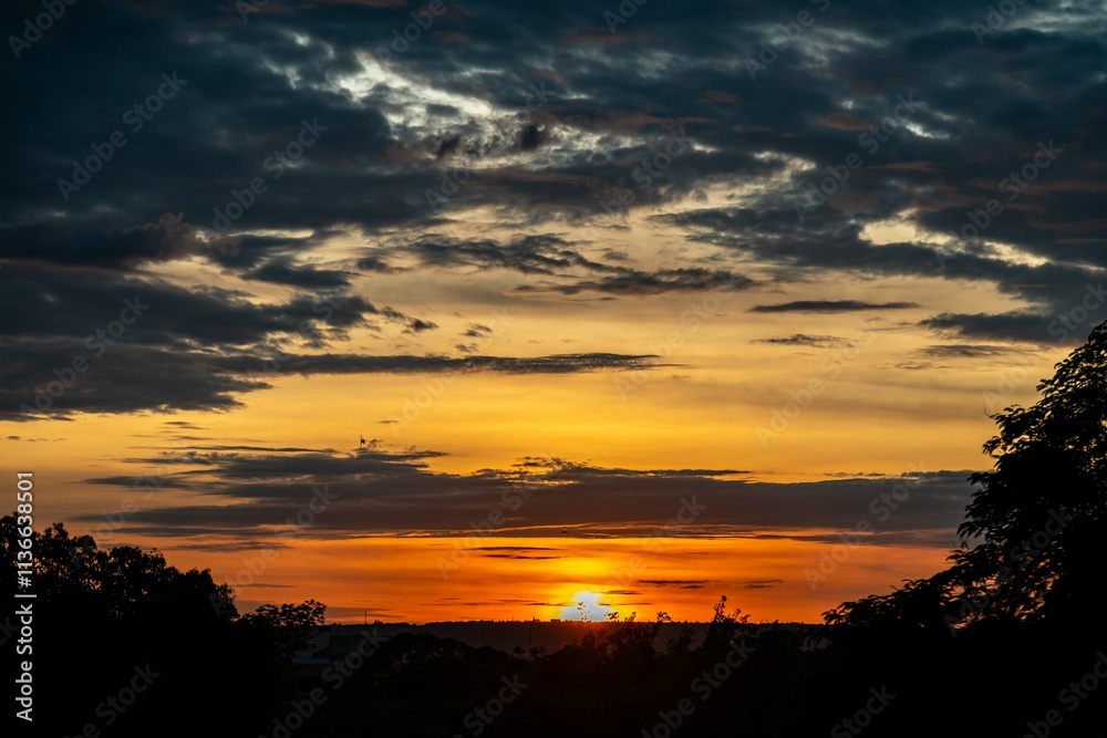 Dramatic sunrise with intense natural orange lights and idyllic dramatic scenery Dramatic sunrise with intense natural orange lights and idyllic dramatic scenery