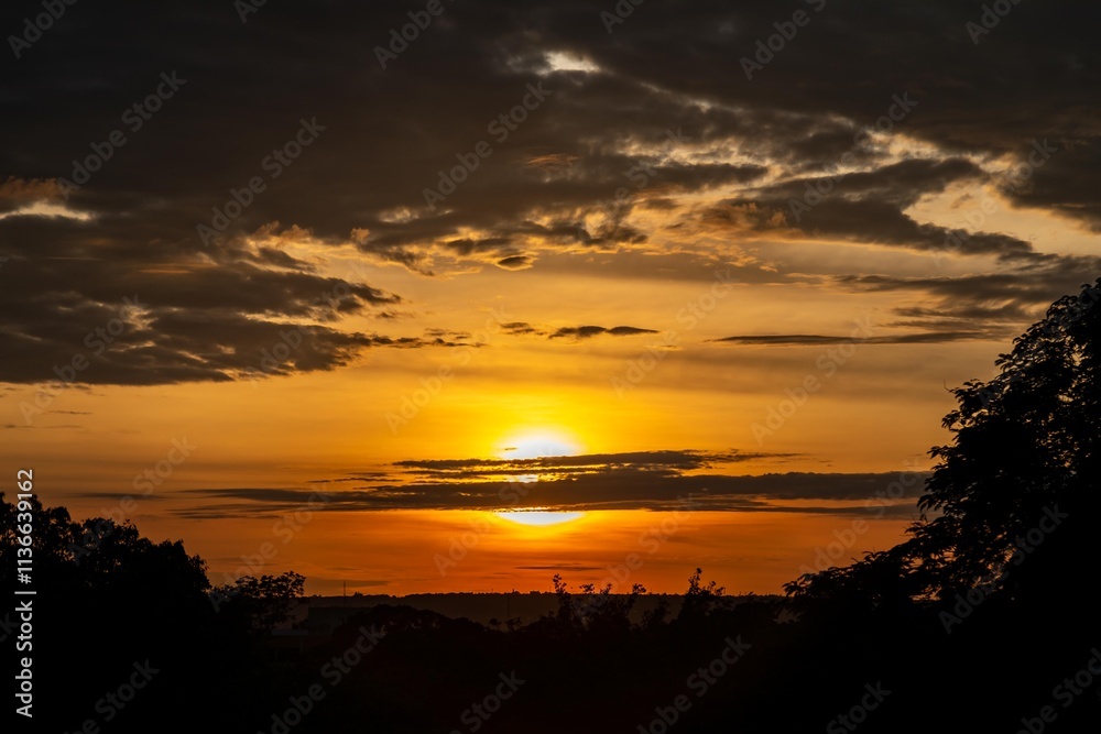 Fototapeta premium Dramatic sunrise with intense natural orange lights and idyllic dramatic scenery