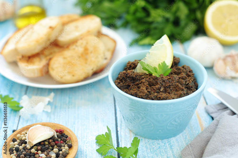 A bowl with tapenade - traditional olive dip in Mediterranean region A bowl with tapenade - traditional olive dip in Mediterranean region