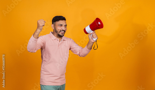 Overexcited Indian man with megaphone cheering on isolated background photo