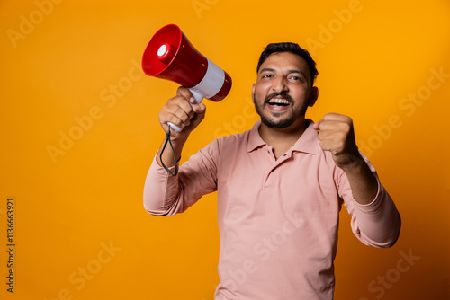 Overexcited Indian man with megaphone cheering on isolated background