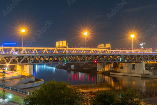 The scyscrapers of the Moscow City at night and the Dorogomilovsky bridge with illumination. Translation of text - street names: Krasnopresnenskaya, center, etc. photo