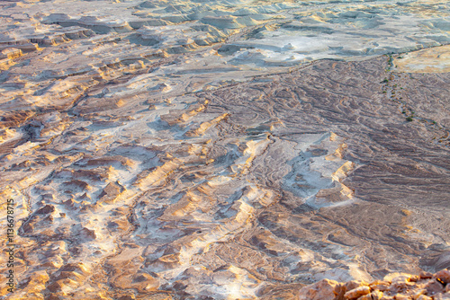 Surface of deserted place loks like as bottom of the ocean with difference ravines.This strange place is located on bottom of Masada mountain.