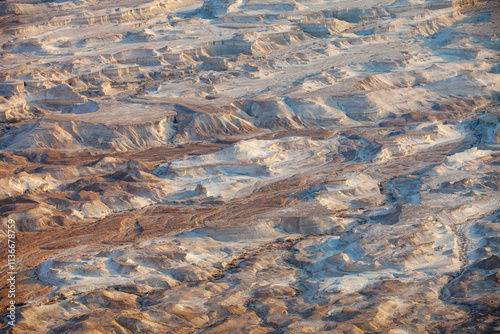 Surface of deserted place loks like as bottom of the ocean with difference ravines.This strange place is located on bottom of Masada mountain.