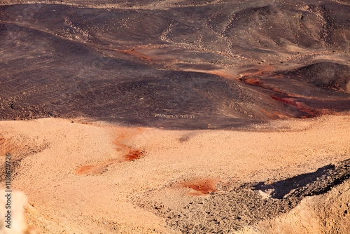 Fragment Makhtesh Ramon  surface, that looks like an some cosmic landscape of Mars planet with craters, hills and desert colored in red and dark brown shades