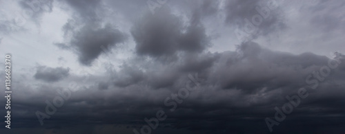The dark sky filled with swirling clouds forebodes an approaching windstorm, showcasing the power of nature's forces and the dramatic shifts in weather during turbulent atmospheric conditions.