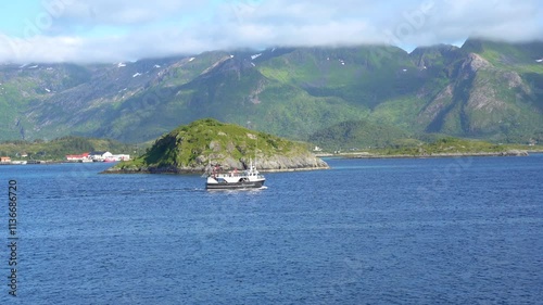 Small ship next to Gimsoystraumen Bridge in the Lofoten islands, Norway photo