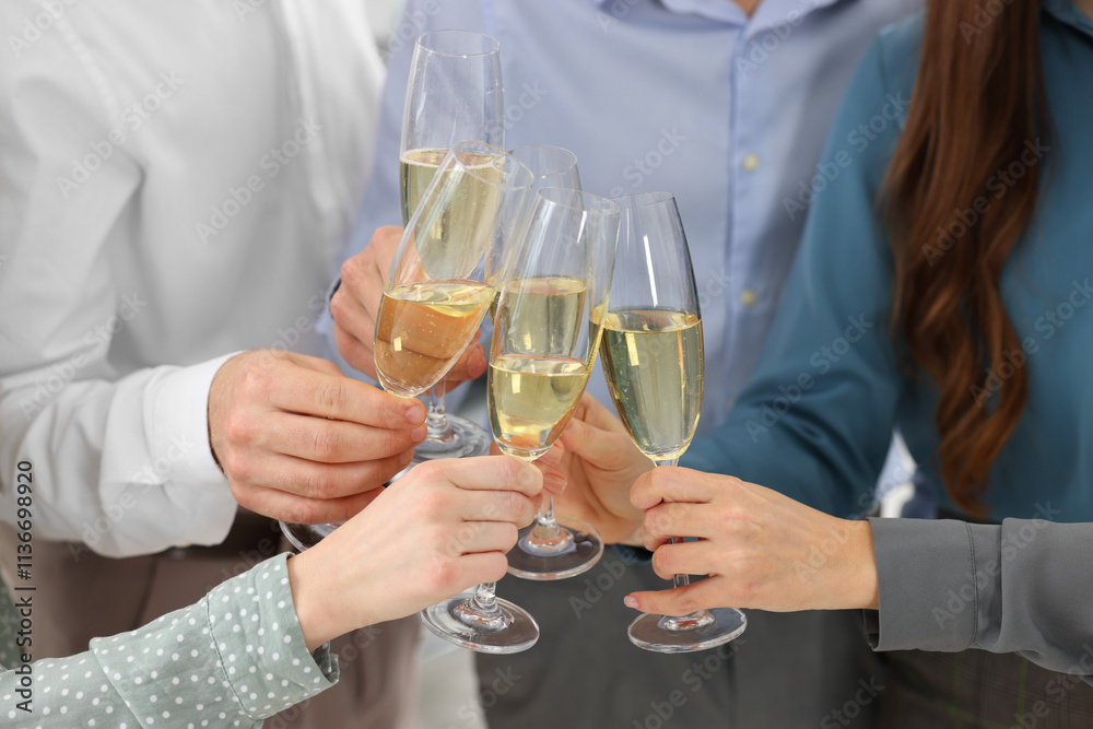 Happy coworkers clinking glasses of wine during office Christmas party, closeup Happy coworkers clinking glasses of wine during office Christmas party, closeup