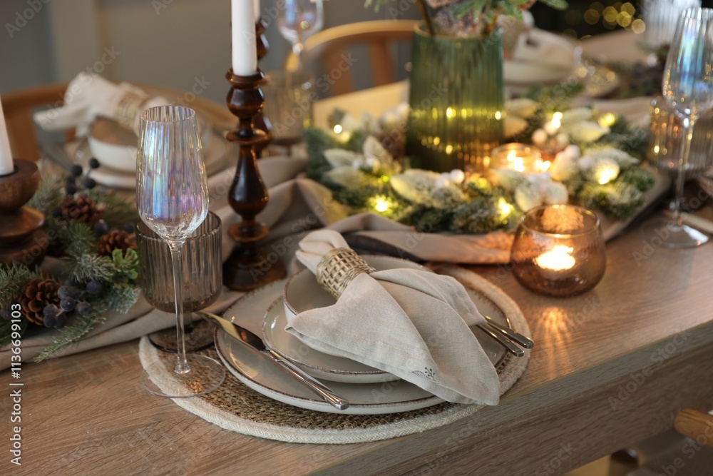 Christmas place setting with festive decor on wooden table in room, closeup Christmas place setting with festive decor on wooden table in room, closeup