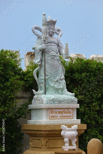 Bangkok, Thailand on 23 July 2023. Detailed Exterior Statue of Vaisravana, Guardian Deity, in a Thai Temple photo