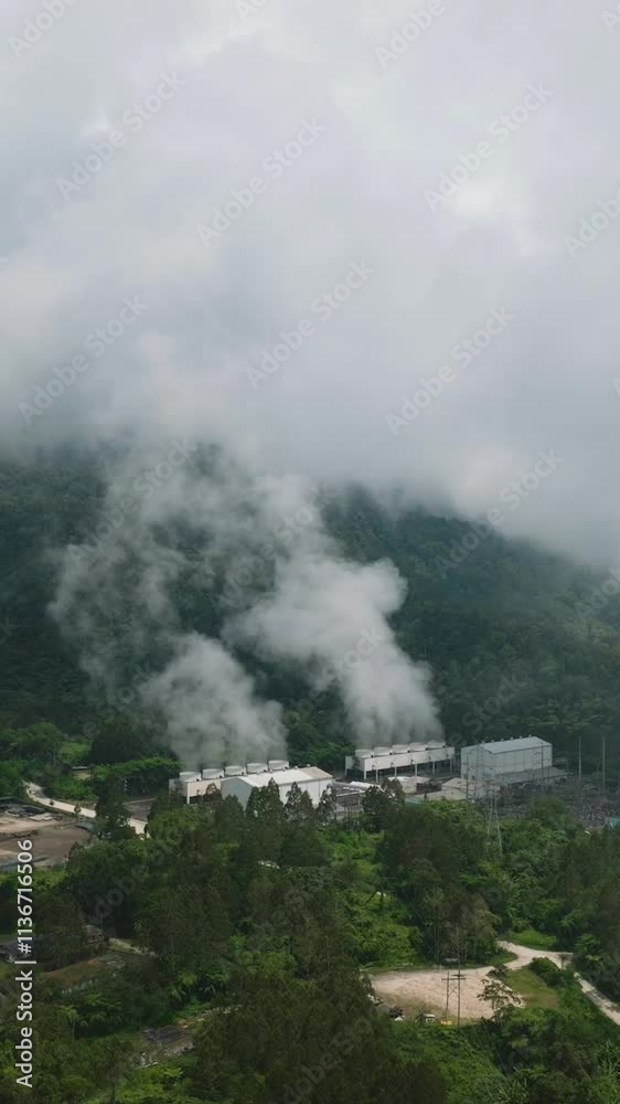 Drone view of Geothermal Production Field with steam and pipes. Renewable energy production at a power station. Mindanao, Philippines. Vertical view. Drone view of Geothermal Production Field with steam and pipes. Renewable energy production at a power station. Mindanao, Philippines. Vertical view.