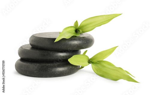 Spa stones and green leaves isolated on white