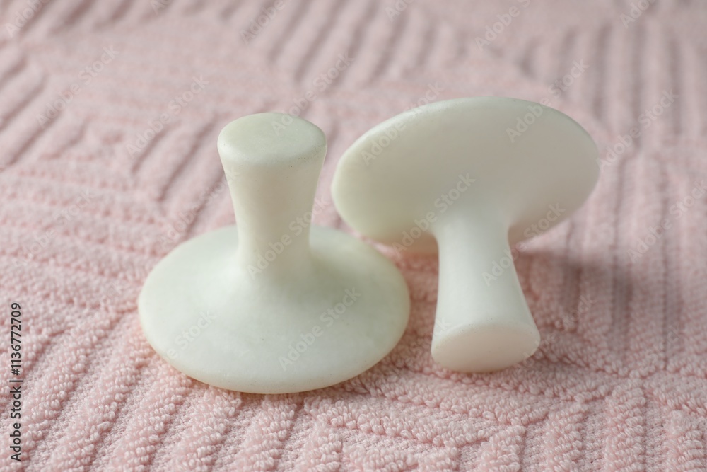 Obraz premium Two spa stones on pink towel, closeup