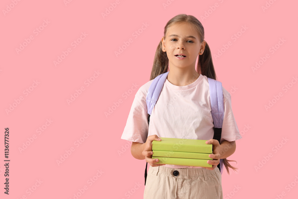 Cute schoolgirl with books and backpack on pink background Cute schoolgirl with books and backpack on pink background