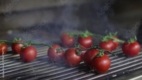 Slow-motion of the steam going out of the grill with some tomatoes on it