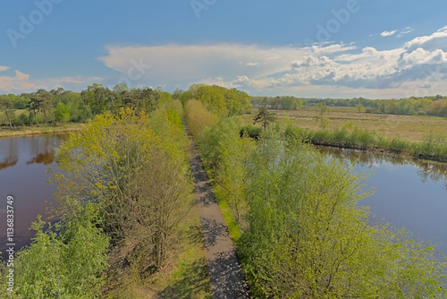  `Bels lijntje`, famous biking and hiking path along the heath and peat lakes of Turnhoutse Vennen nature reserve, Flanders, Belgium.  photo