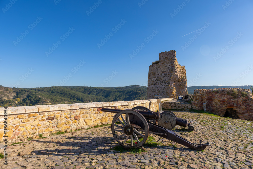 Two historical cannon on old stone floor and stone walls in old historical castle
