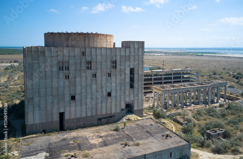 An aerial view of the abandoned construction of a nuclear power plant.  Monolithic building of the first power unit with reactor. Shot from a drone.