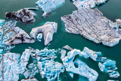 Jokulsarlon glacial lagoon, Iceland at sunset. Beautiful blocks of ice and some seals flow through the cold water coming off the mountain. Landscape of the largest glacier in Iceland and Europe