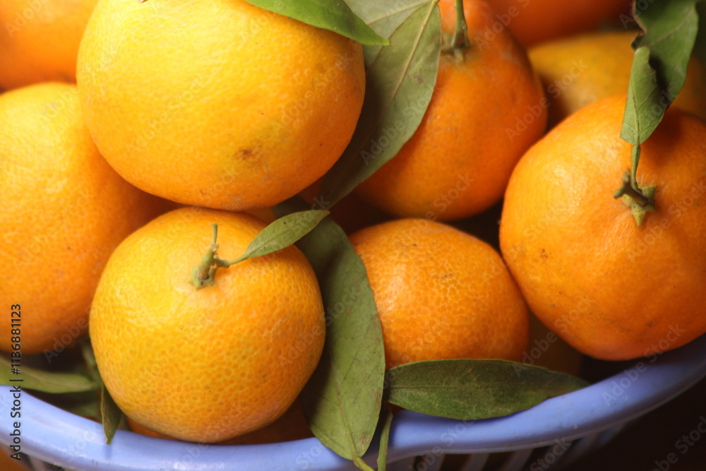 Fresh Small Oranges with Green Leaves Fresh Small Oranges with Green Leaves