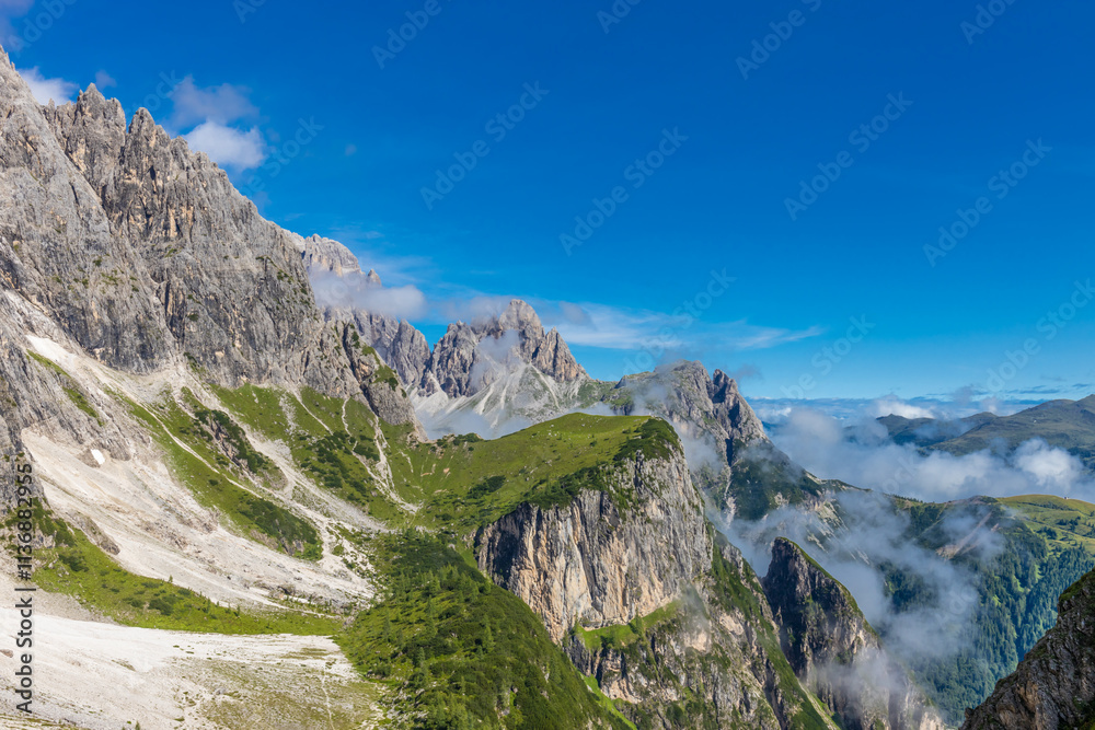 Obraz premium Dolomites sunny weather in summer mountains. Green valley and beautiful mountain rocky peaks in the Alps. Alpine scenic landscape in South Tyrol region in Italy