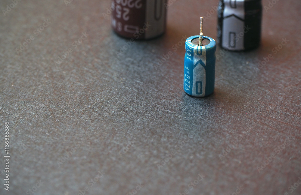 Through-hole electrolytic capacitors on a black with text space.