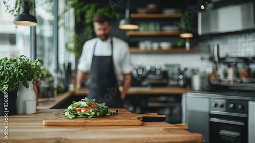 A chef adorned in an apron artfully prepares a fresh salad on a wooden countertop, surrounded by rustic kitchen décor, promoting healthy eating and culinary creativity. photo