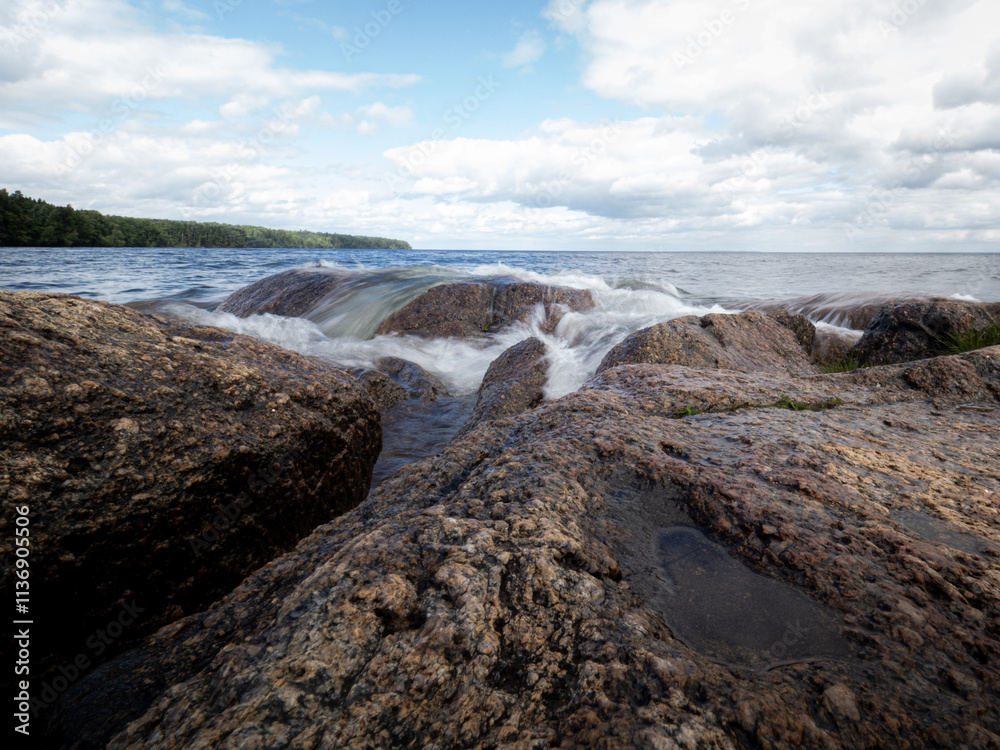 The movements of waves at the shoreline of the Swedish lake Vättern in the southern Sweden. The movements of waves at the shoreline of the Swedish lake Vättern in the southern Sweden.