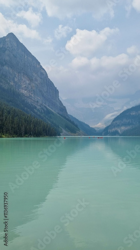 The iconic Lake Louise in summer located in Alberta, Canada with blue sky background overlooking the stunning turquoise lake.