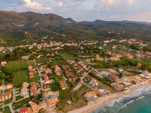 Aerial view of a coastal town nestled amidst lush greenery and rolling hills.Axaravi in corfu island.Greece photo