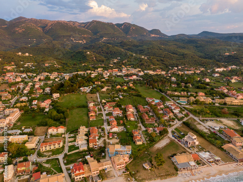 Aerial view of a coastal town nestled amidst lush greenery and rolling hills.Axaravi in corfu island.Greece photo